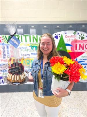 Camryn Story with flowers and a cake