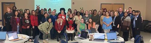 Photo of EC Contacts and District Staff dressed in various holiday attire