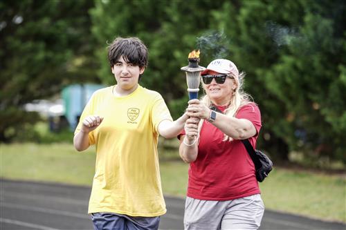 Teacher and student holding torch